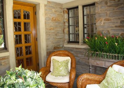 Stone castle walls with leaded and stained glass paneled doors and windows., Brighton, NY